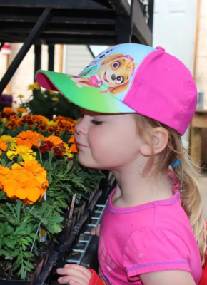 child smelling flower