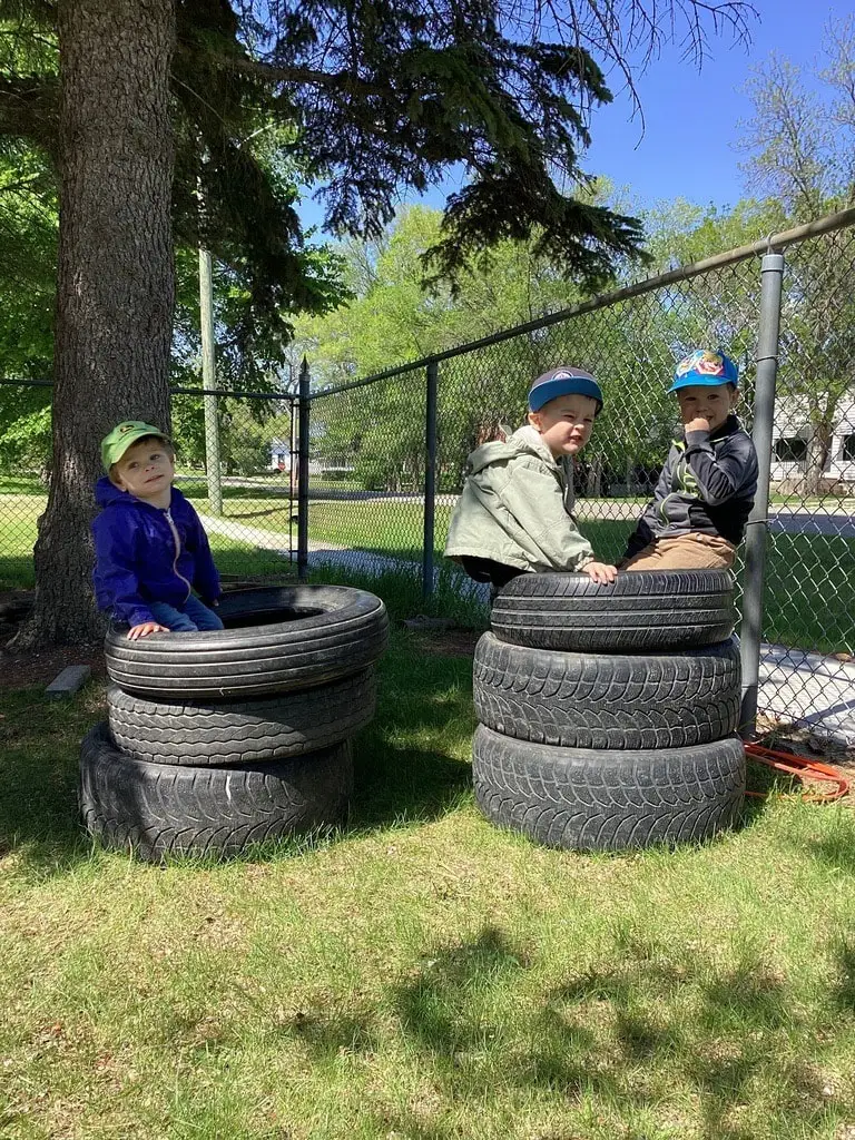 children playing on tires outside