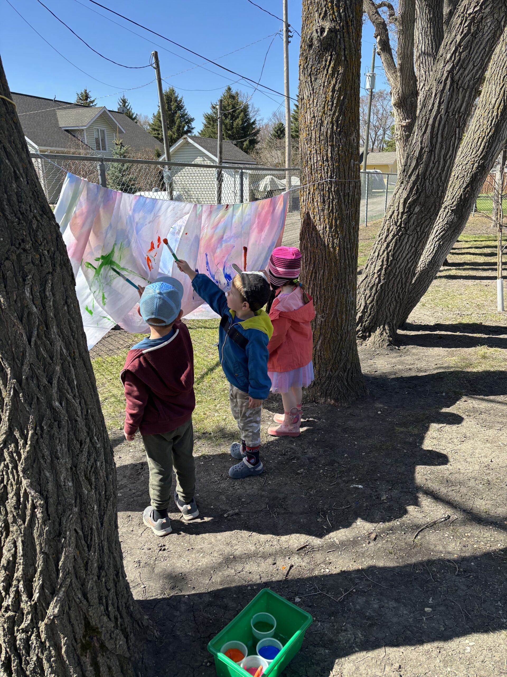 children playing outside beside fence