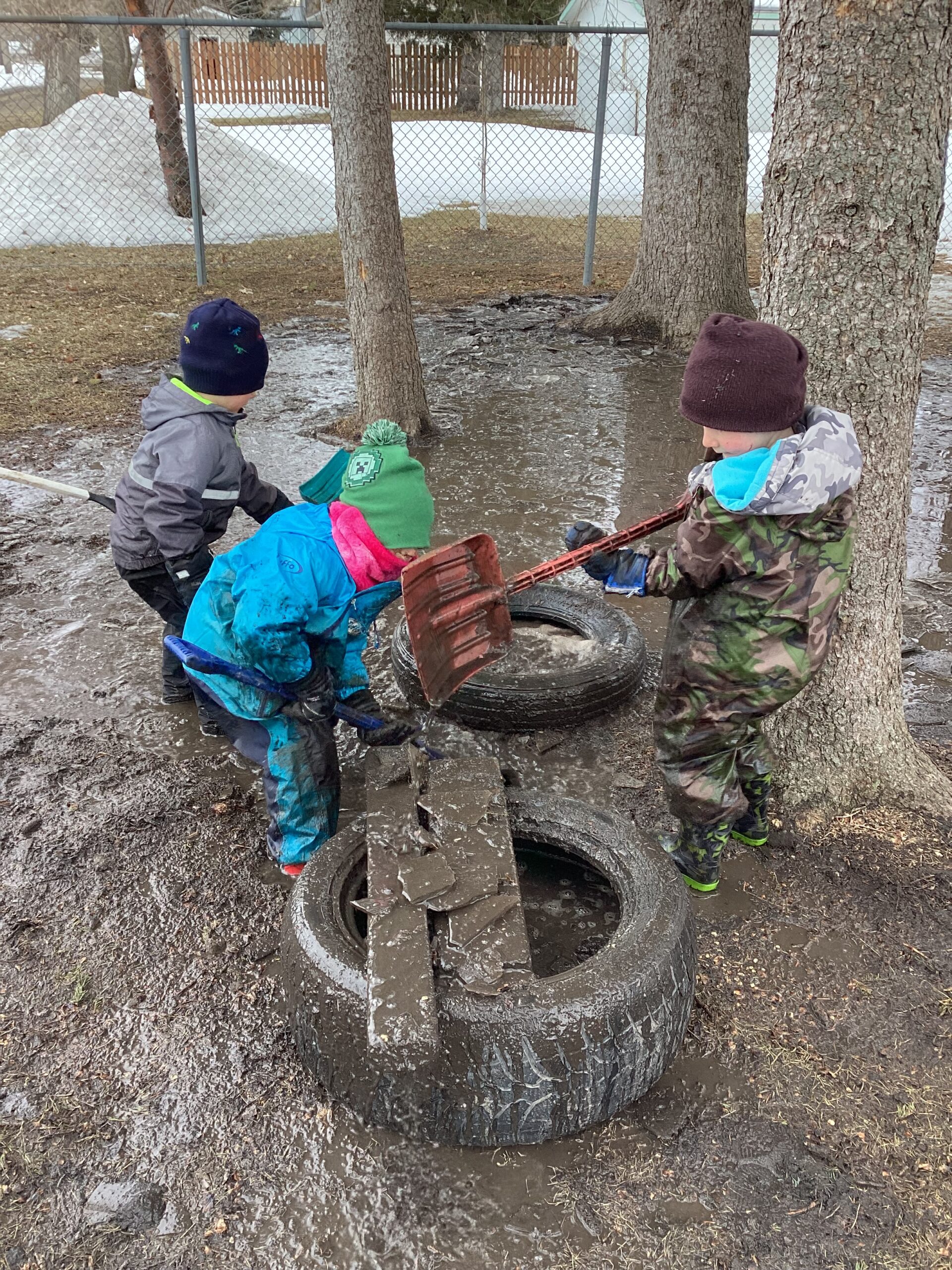 playing on muddy tire swing