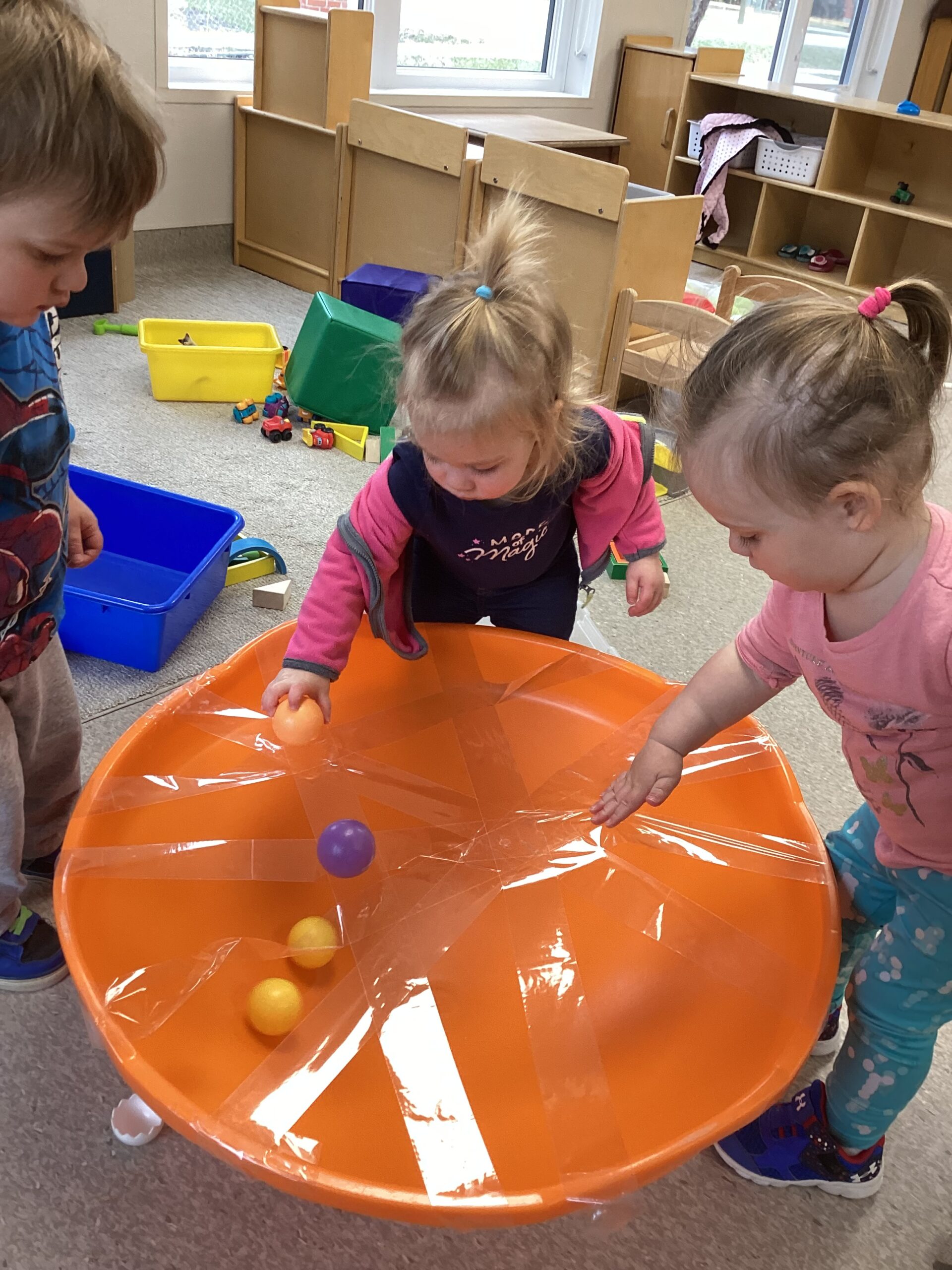 kids playing ball game that is covered in Saran Wrap